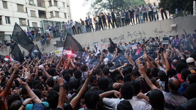 120911054218cairoembassy1storytop 1 - Protesters climb U.S. Embassy walls in Cairo