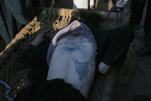 20121216T115835Z 31268751 GM1E8CG1JCM01  1 - A tattoo is seen on the back of a Pakistani Taliban militant